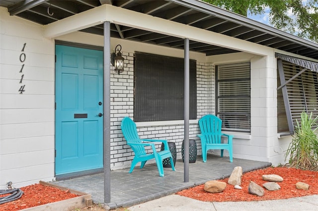 view of exterior entry featuring a porch