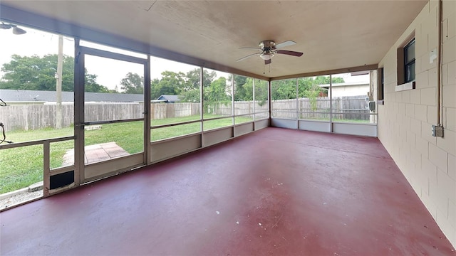 unfurnished sunroom with ceiling fan