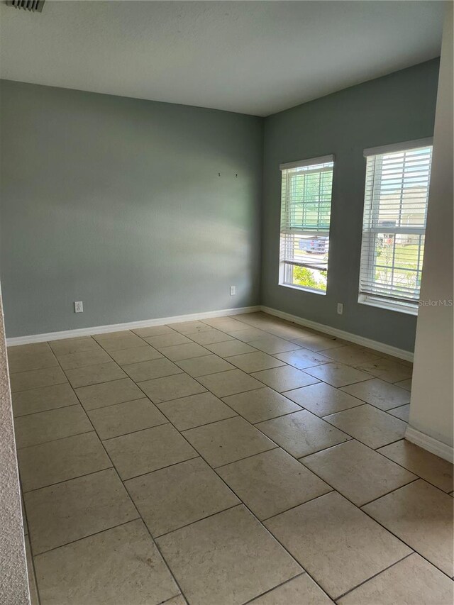 spare room with light tile patterned floors