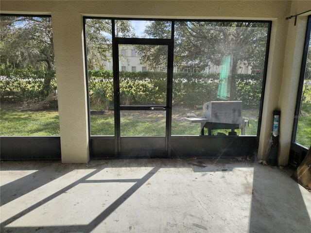 unfurnished sunroom featuring a wealth of natural light