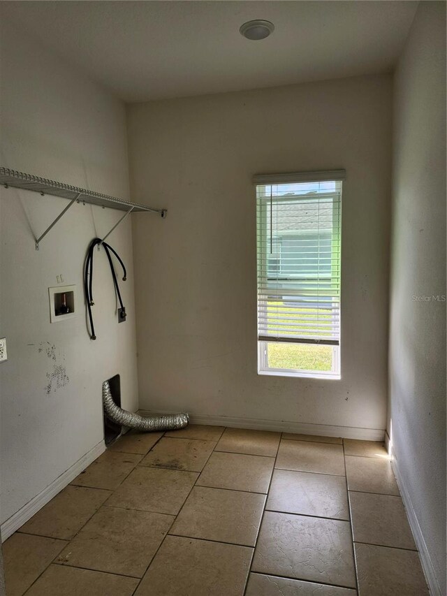 washroom featuring washer hookup and light tile patterned floors