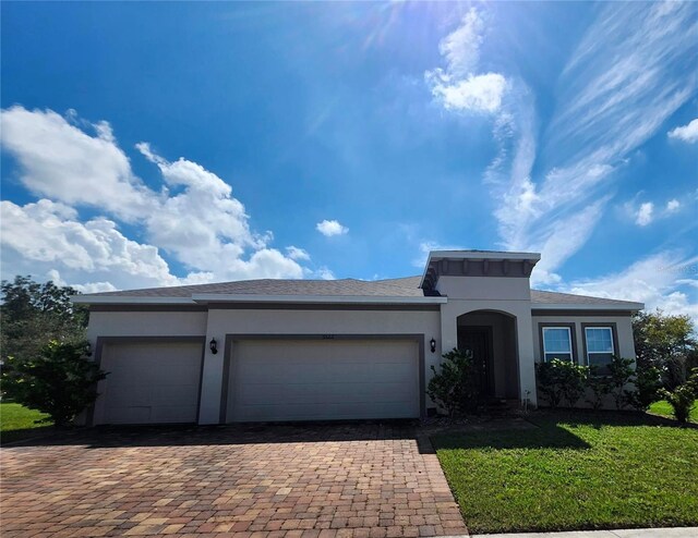 view of front of property featuring a front lawn and a garage