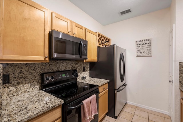 kitchen featuring decorative backsplash, appliances with stainless steel finishes, light tile patterned floors, light stone countertops, and light brown cabinetry