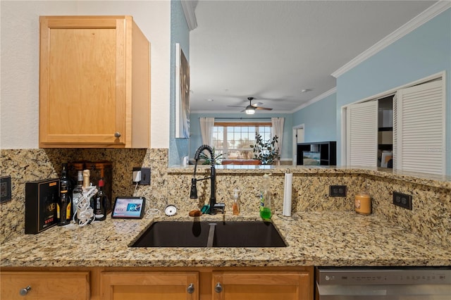 kitchen featuring dishwasher, sink, ornamental molding, ceiling fan, and light stone countertops