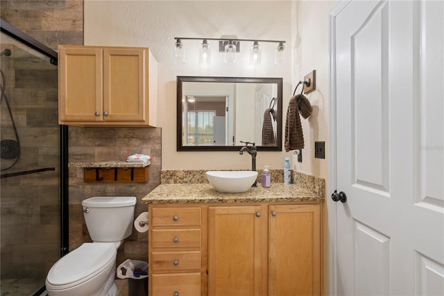 bathroom with walk in shower, vanity, and toilet