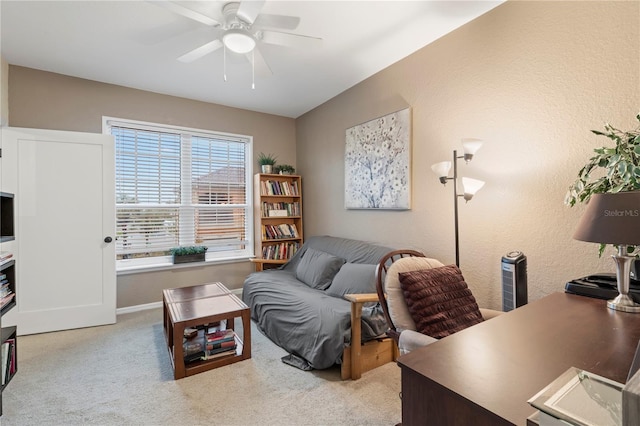 office space with ceiling fan and light colored carpet