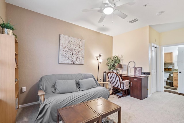 living room with ceiling fan and light colored carpet