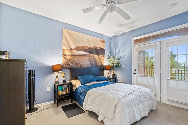 bedroom with access to outside, ceiling fan, and light carpet