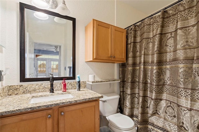 bathroom with vanity, toilet, and curtained shower