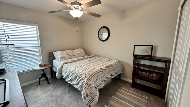 bedroom featuring dark carpet, ceiling fan, and a closet