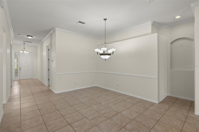 empty room with light tile patterned flooring, crown molding, and a chandelier