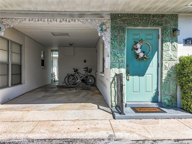 doorway to property featuring a carport