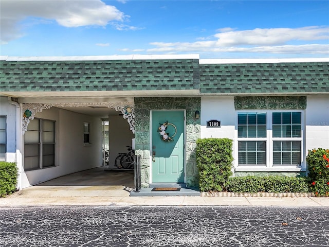 property entrance featuring a carport