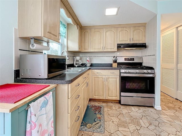 kitchen with backsplash, a textured ceiling, sink, light brown cabinets, and stainless steel stove