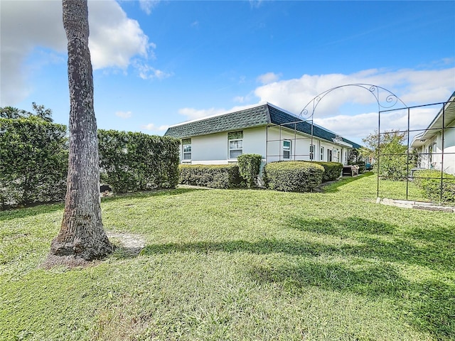 view of property exterior with a lawn