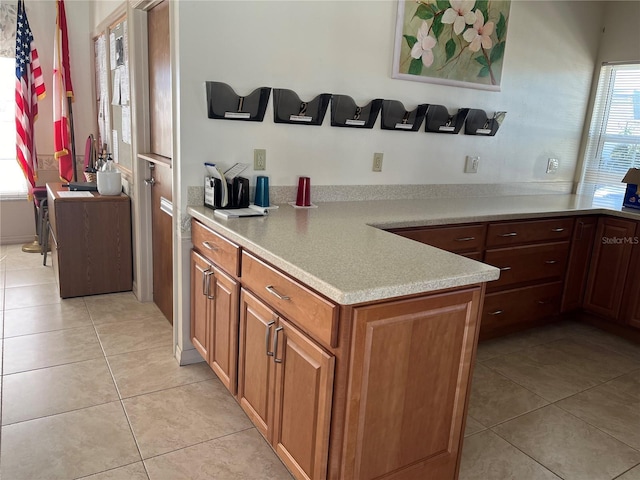 kitchen featuring light tile patterned flooring and a healthy amount of sunlight