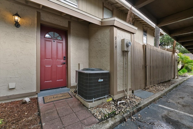 view of exterior entry with central air condition unit