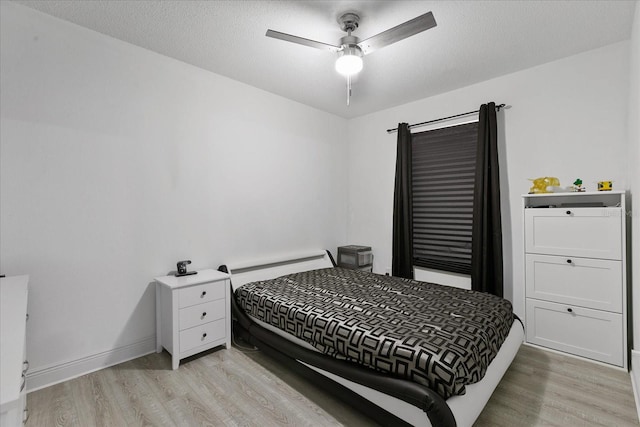 bedroom featuring ceiling fan and light hardwood / wood-style floors