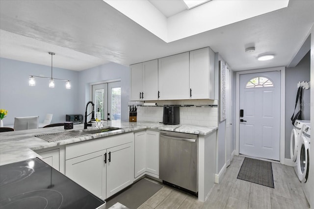 kitchen with light stone countertops, dishwasher, decorative backsplash, white cabinets, and separate washer and dryer