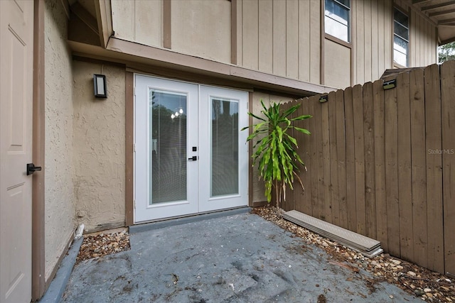 view of exterior entry with french doors and a patio