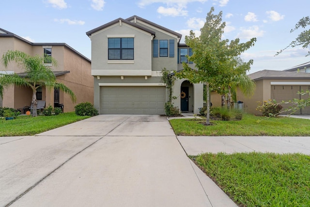 view of front of home featuring a front lawn and a garage