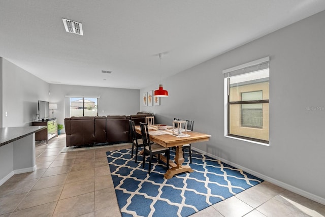 dining area with light tile patterned floors