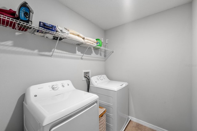 clothes washing area with washing machine and dryer