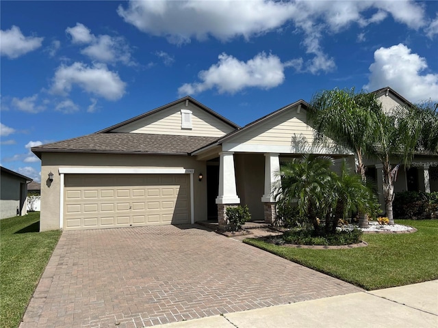 view of front of home featuring a front yard and a garage