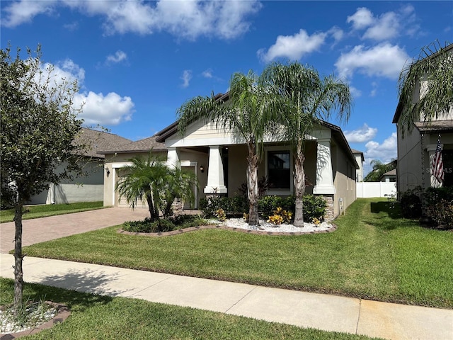 view of front facade featuring a front yard and a garage