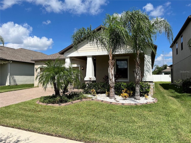 view of front of house with a garage and a front yard