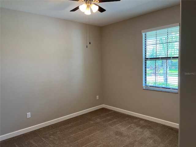 carpeted spare room featuring ceiling fan