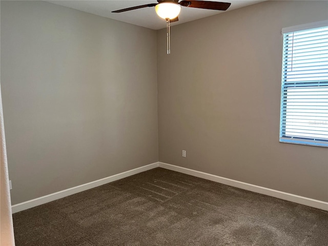 carpeted spare room featuring ceiling fan