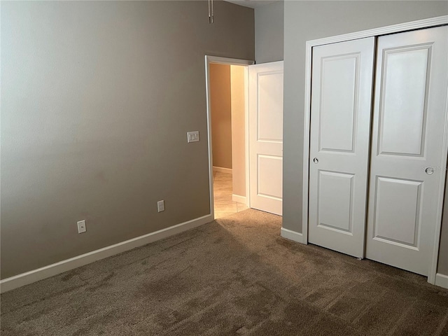 unfurnished bedroom featuring a closet and carpet flooring