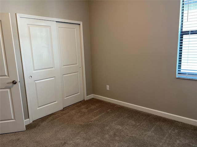 unfurnished bedroom featuring carpet floors and a closet