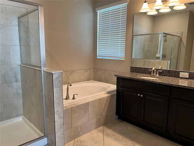 bathroom with shower with separate bathtub, tile patterned floors, and vanity