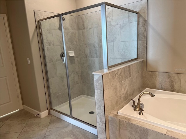 bathroom with independent shower and bath and tile patterned floors