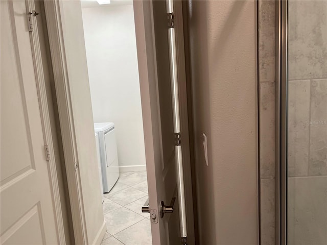 washroom with independent washer and dryer and light tile patterned floors