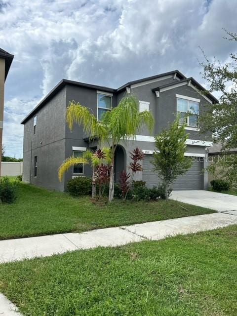 view of front of home featuring a garage and a front lawn