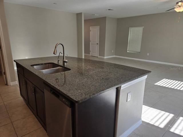 kitchen featuring an island with sink, stainless steel dishwasher, light tile patterned floors, and sink