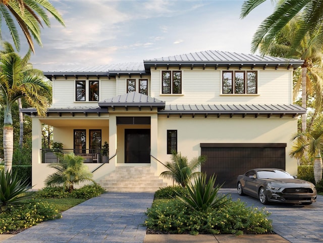 view of front facade featuring covered porch and a garage