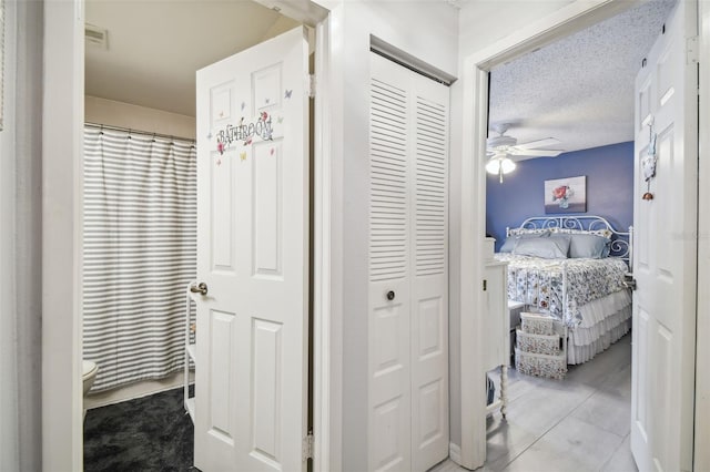 hall featuring a textured ceiling