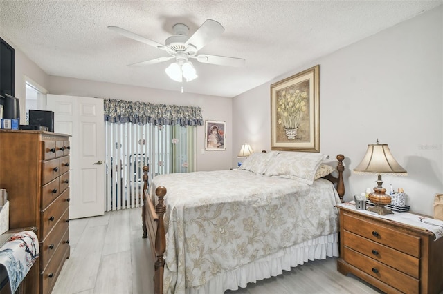 bedroom with ceiling fan, a textured ceiling, and light hardwood / wood-style flooring