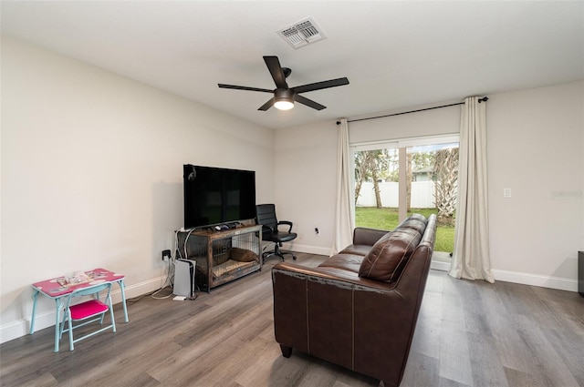 living room with ceiling fan and hardwood / wood-style flooring