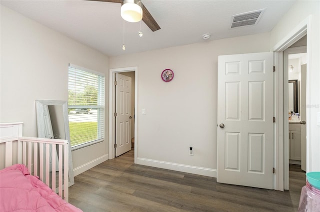 unfurnished bedroom featuring ceiling fan, dark wood-type flooring, and a textured ceiling