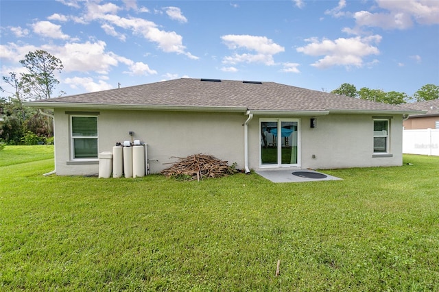 rear view of house with a yard