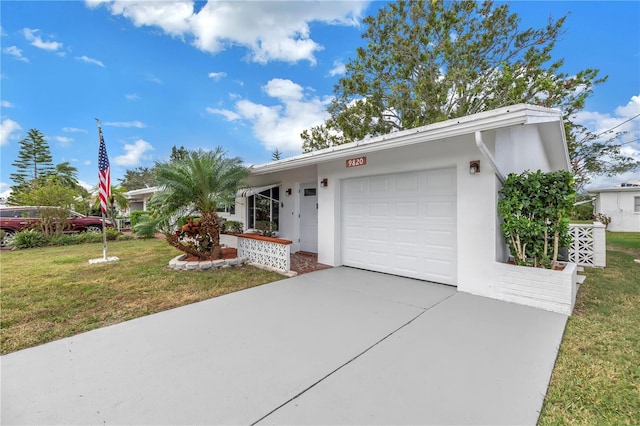 single story home featuring a garage and a front lawn