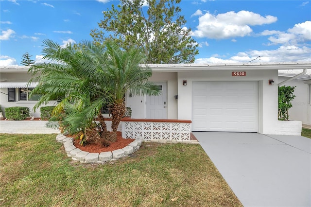 ranch-style home featuring a garage and a front lawn