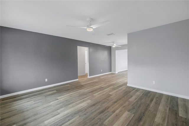 spare room featuring wood-type flooring and ceiling fan