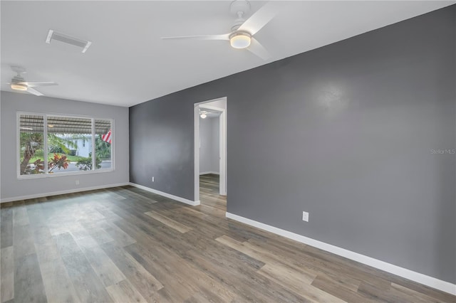 empty room featuring hardwood / wood-style flooring and ceiling fan