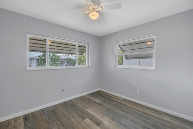 spare room featuring dark wood-type flooring and ceiling fan